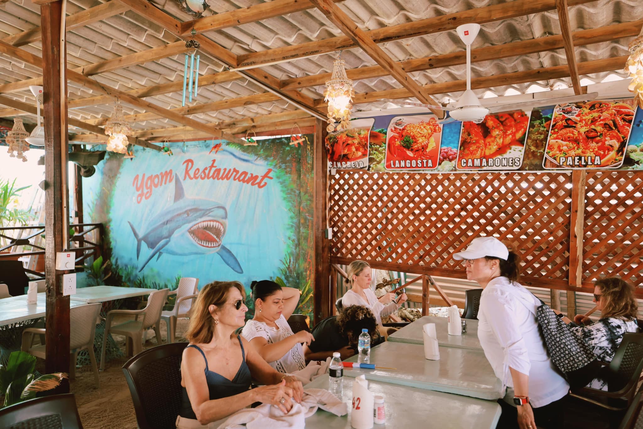 Interior of Ygom Restaurant with shark mural and seafood menu