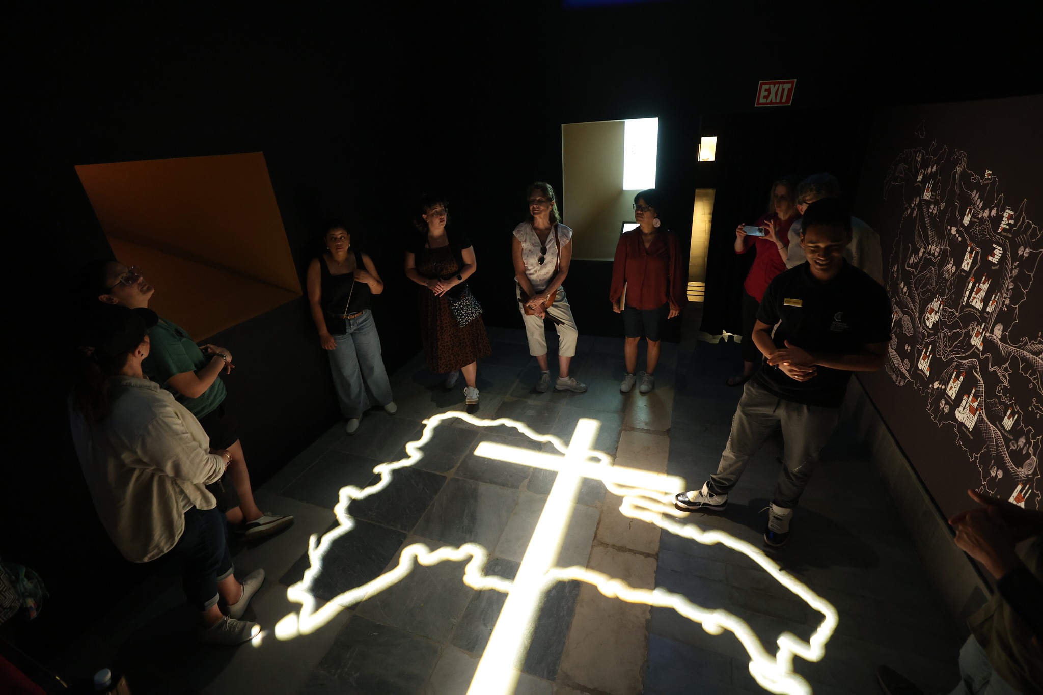 Light projection of Dominican Republic map with cross on floor during guided tour