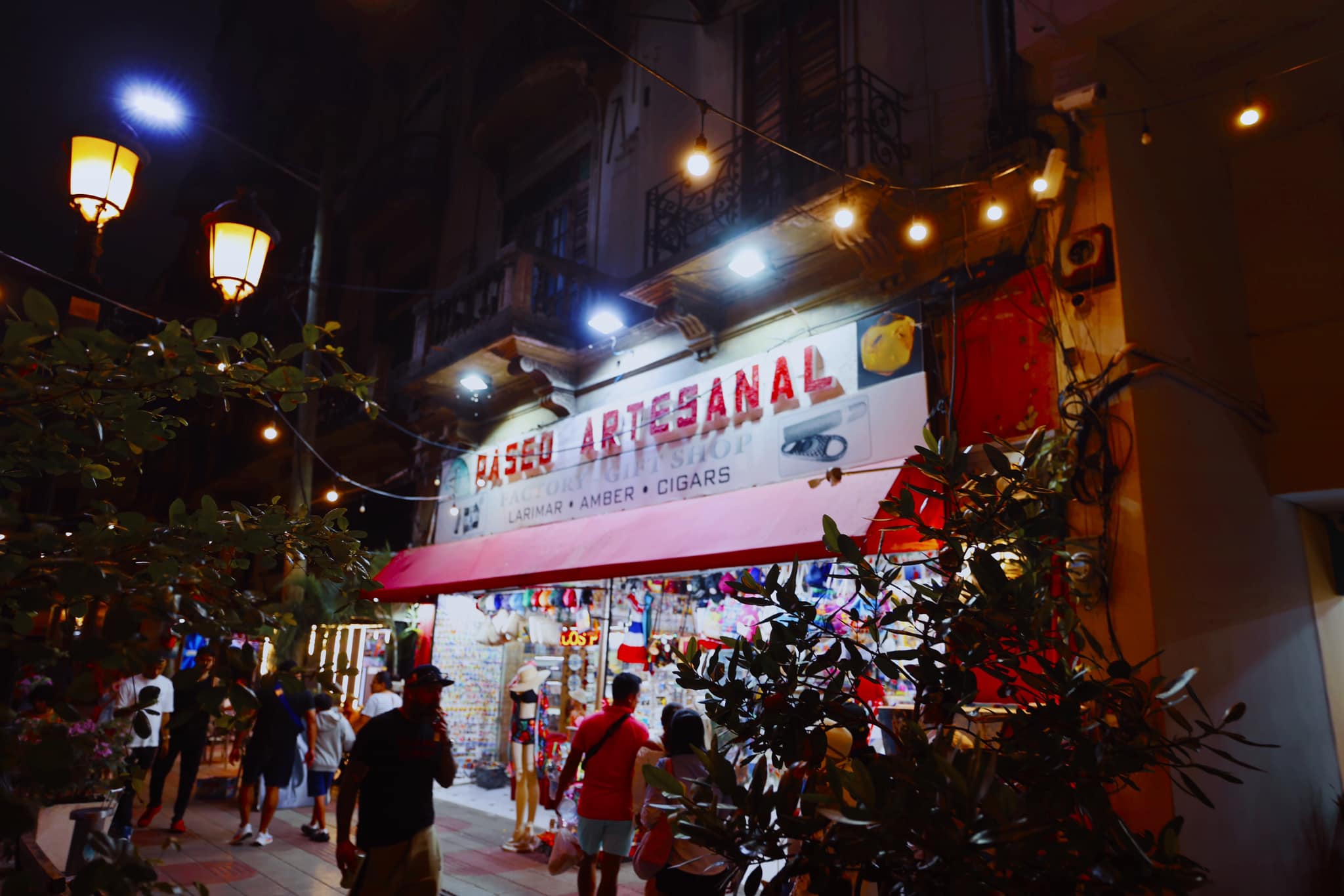Paseo Artesanal shop lit up at night selling larimar, amber and cigars