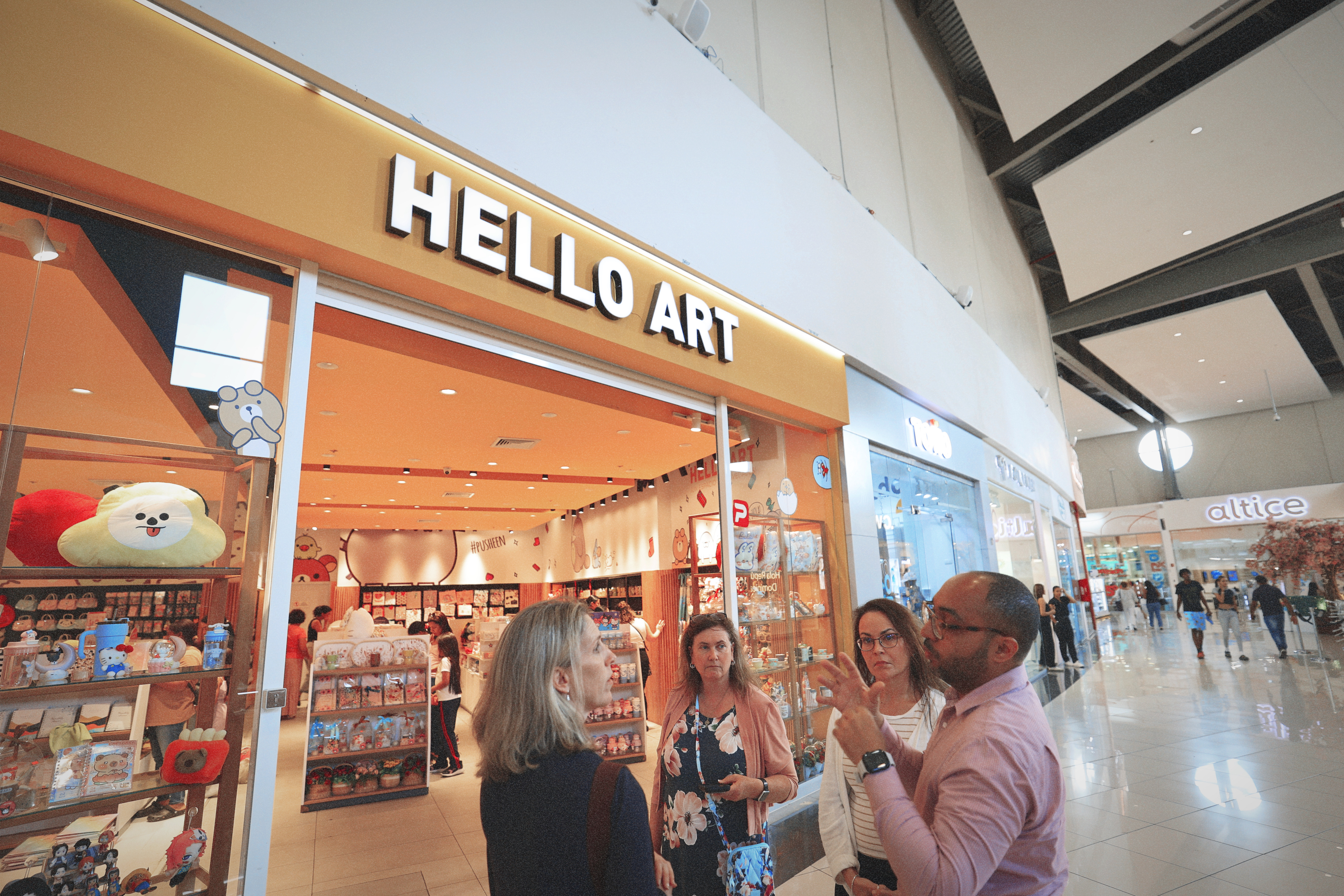 Group discussion outside Hello Art store with colorful merchandise