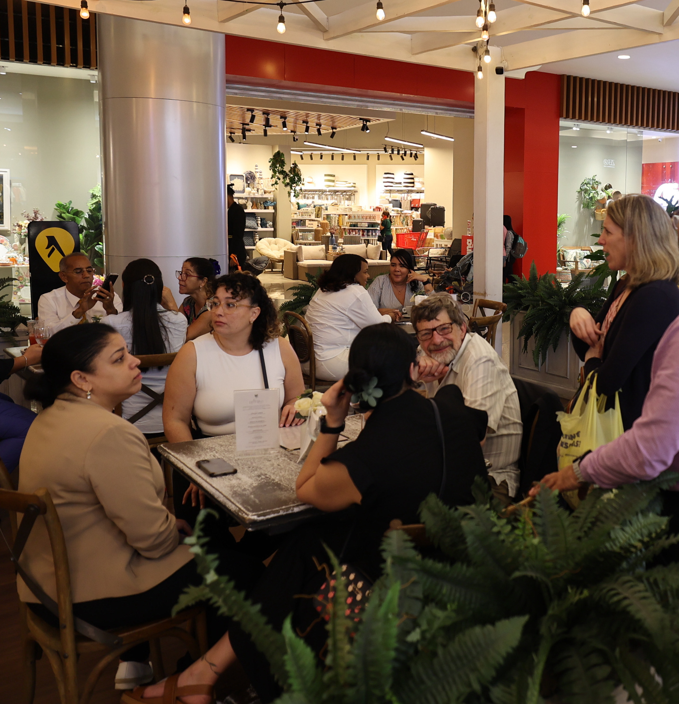 Group enjoying refreshments at a stylish café in the mall