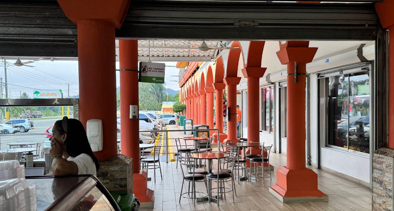 Interior view of rest area with bright orange columns and outdoor seating