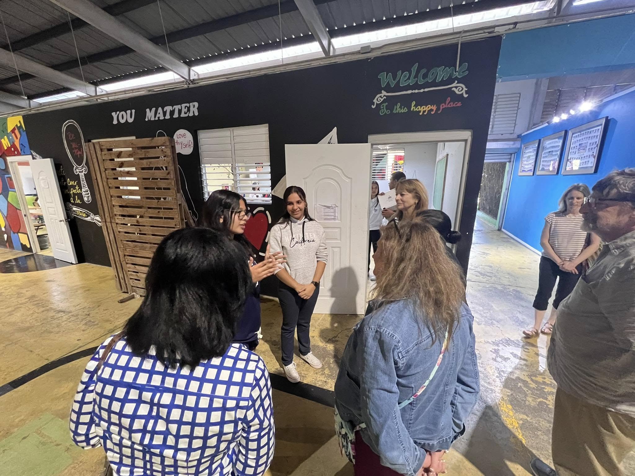 Student explaining the 'You Matter' positive environment philosophy in workshop space