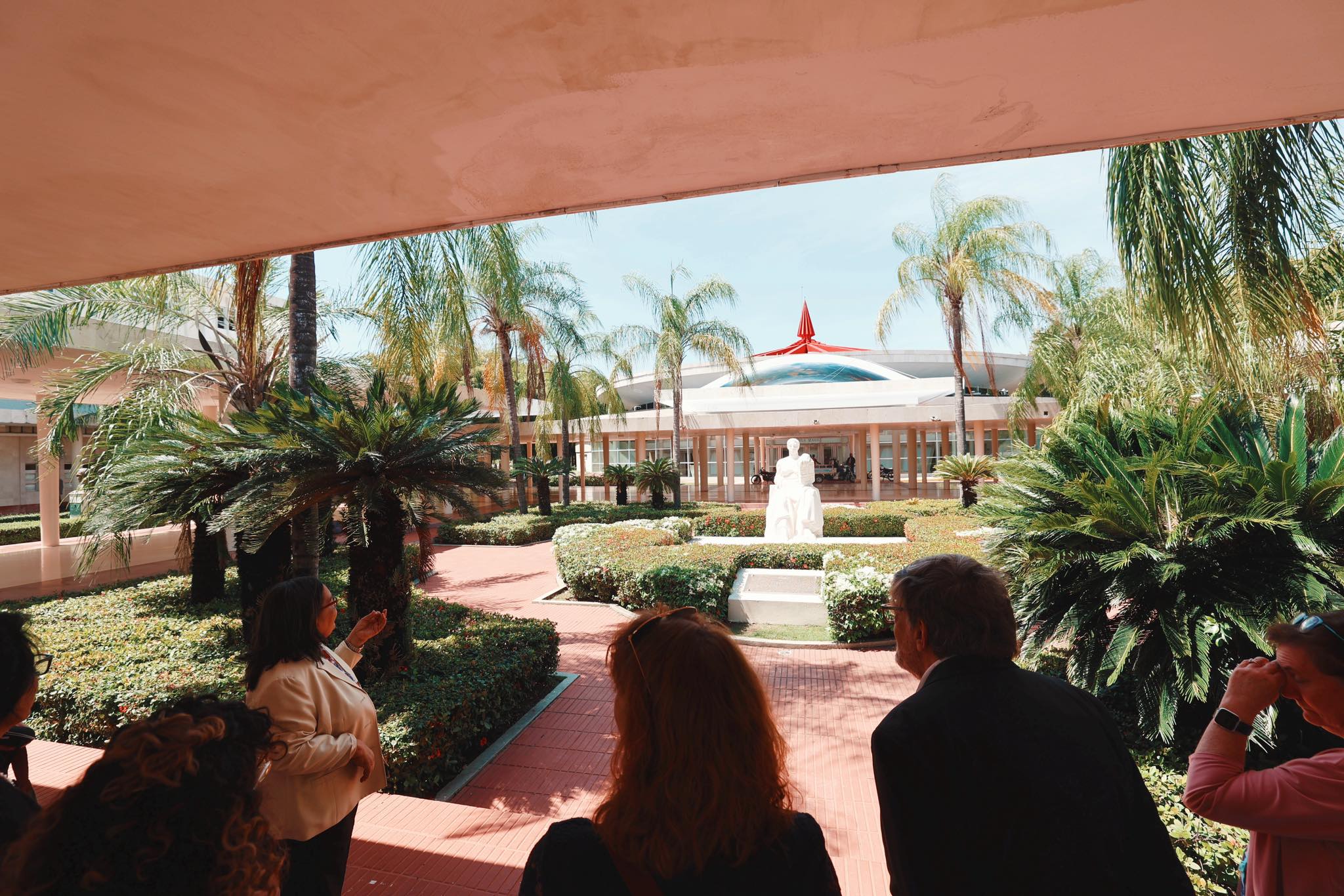 Our group viewing the beautifully landscaped courtyard with palm trees and white statue
