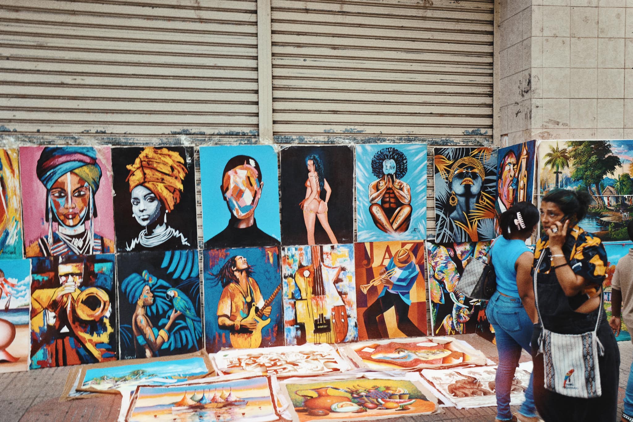 Local art display with colorful paintings along the street