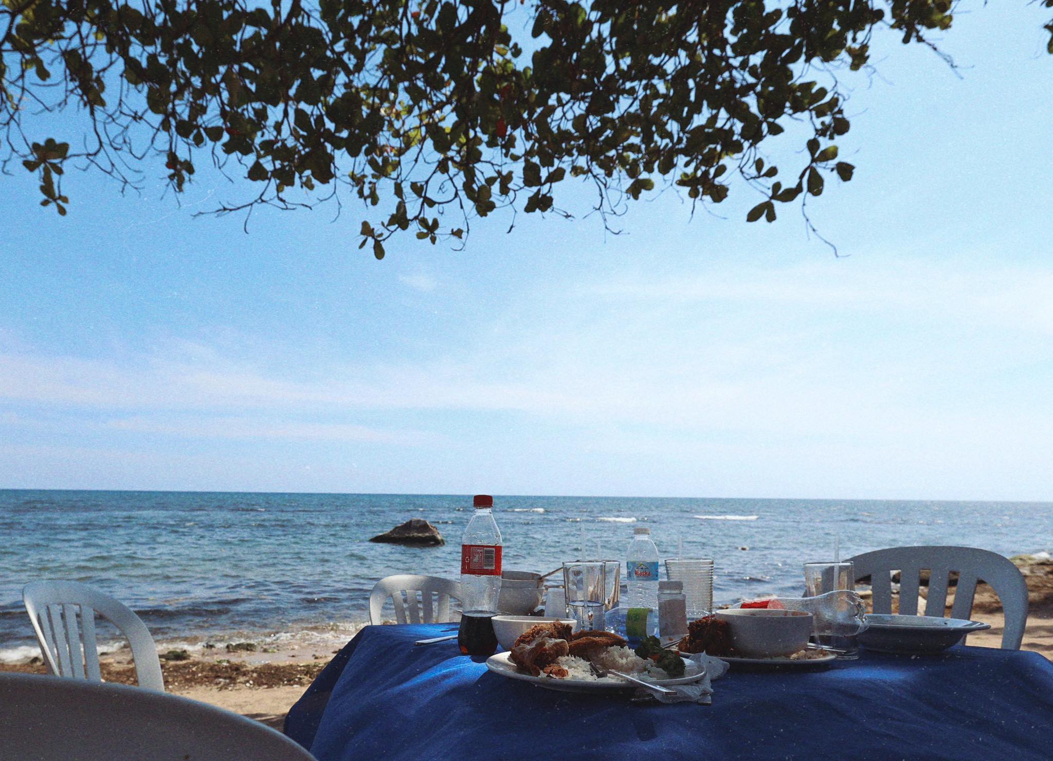 Beachfront table with Dominican lunch spread and ocean view